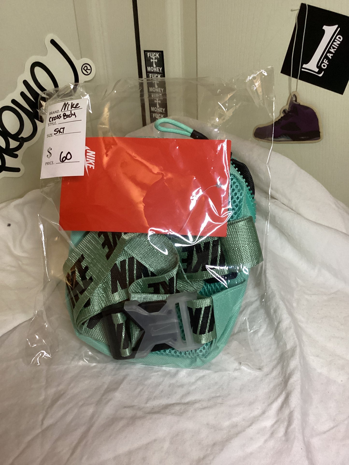 Back view of Nike Crossbody Bag 5x7 in teal tactical utility sling style, showing strap and design details while still inside the bag from ShAesthetics
