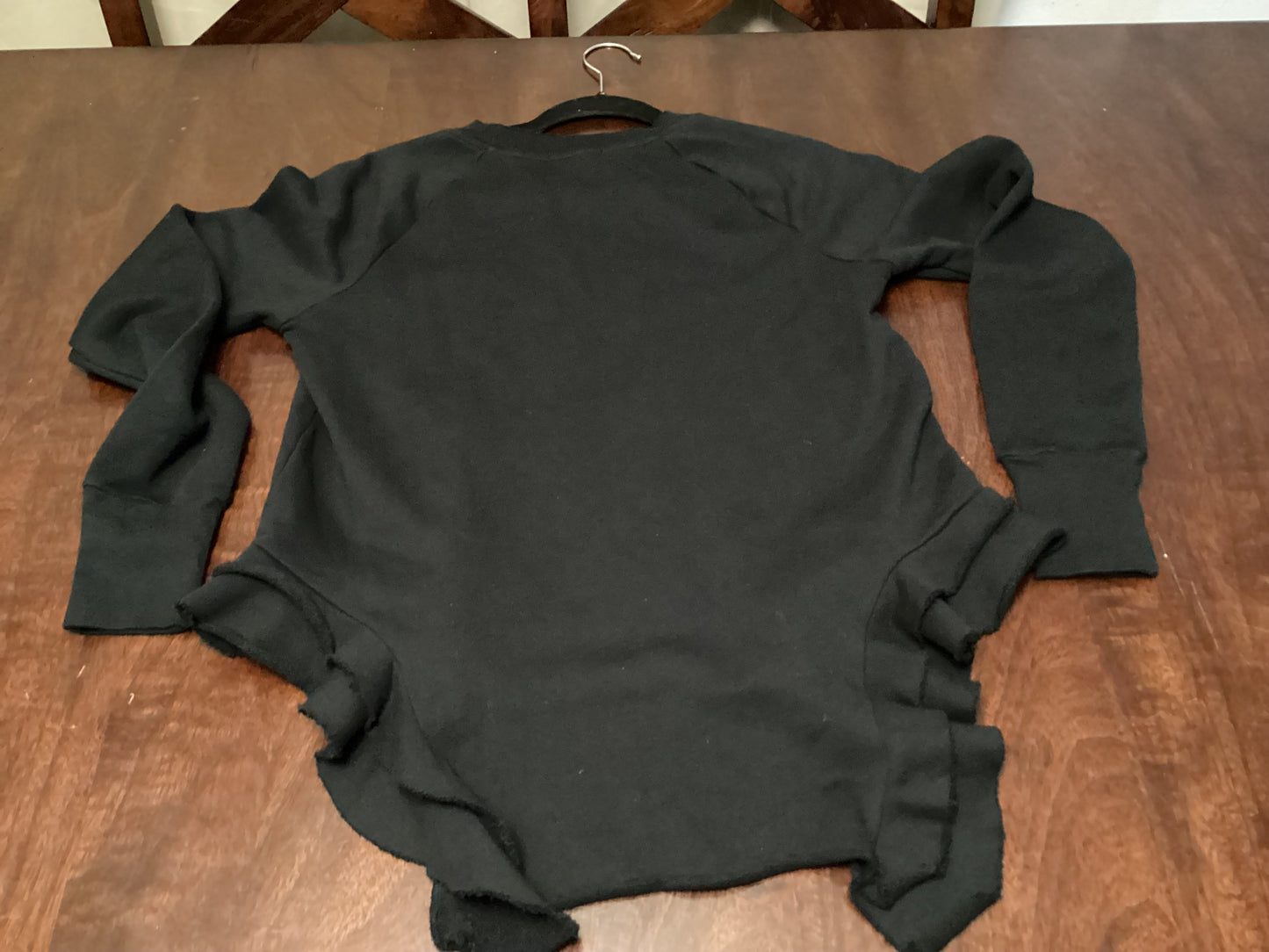 Front view of Black Orchid LA Double Ruffle Sweat Sweater in jet black, size small, combining cozy comfort with elegant double ruffle design from ShAesthetics