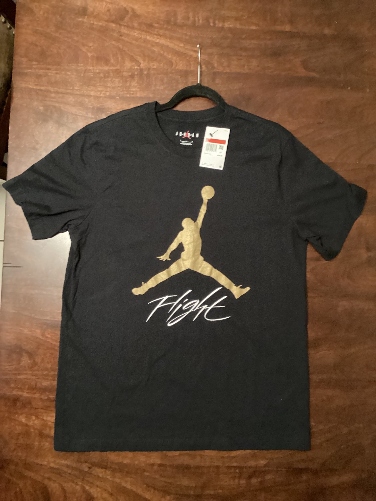 Jordan Flight Tee in black with metallic gold print, 2021 throwback edition, size large, a stylish retro streetwear staple from ShAesthetics