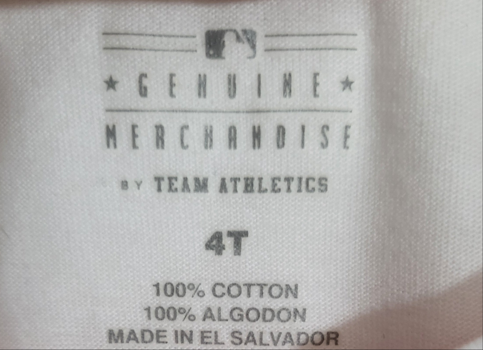 Close-up of inside label showing MLB Genuine Merchandise branding and size 4T on cotton shirt