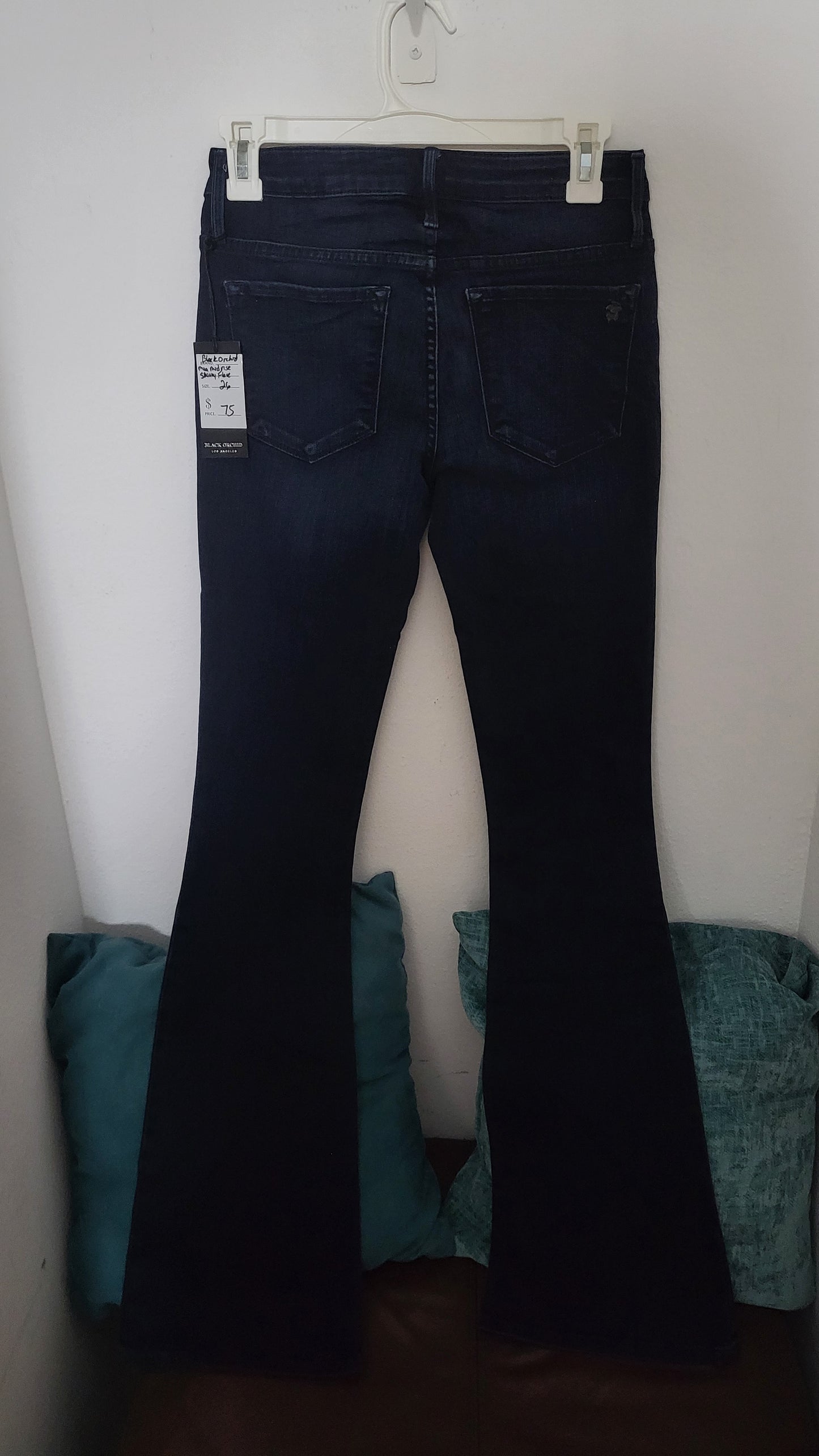 Back view of Black Orchid Mia Mid Rise Skinny Flare jeans emphasizing the flattering flare and clean finish, a versatile piece from ShAesthetics’ collection