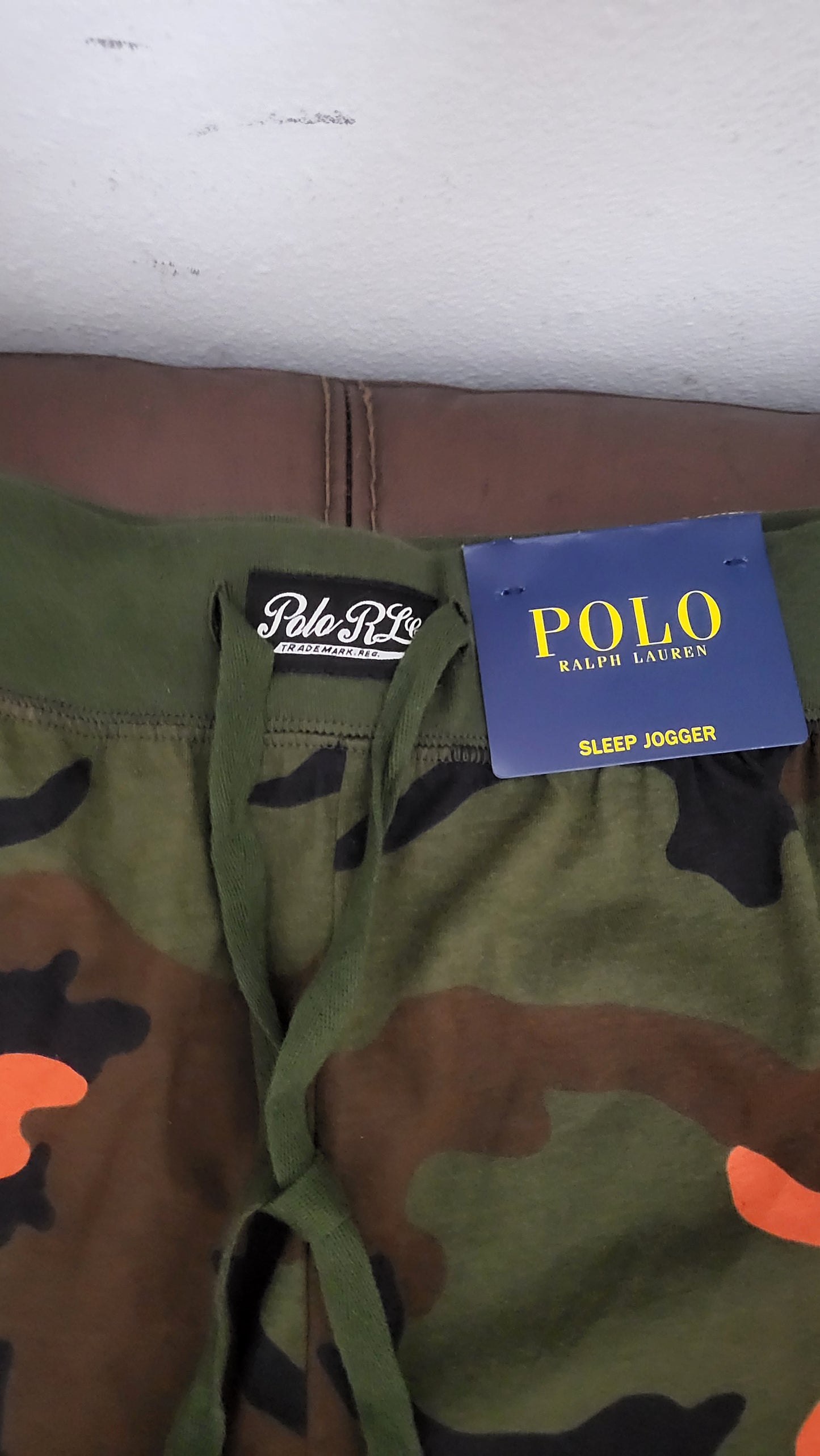 Close-up of waistband and label on Polo camo joggers, showing drawstring and fleece texture