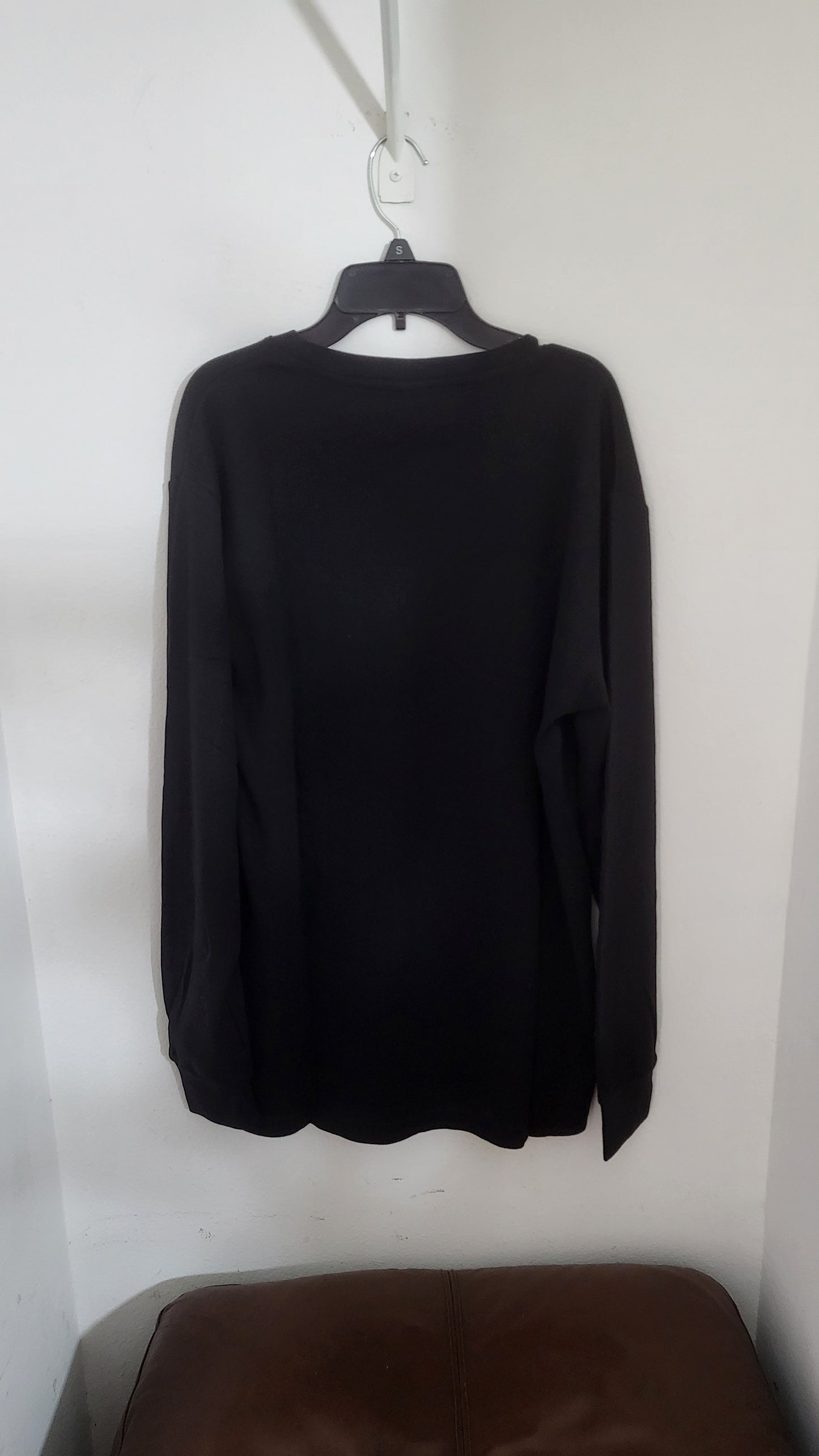Back of black Melrose Place long sleeve shirt, size M, showing full silhouette and ribbed cuffs