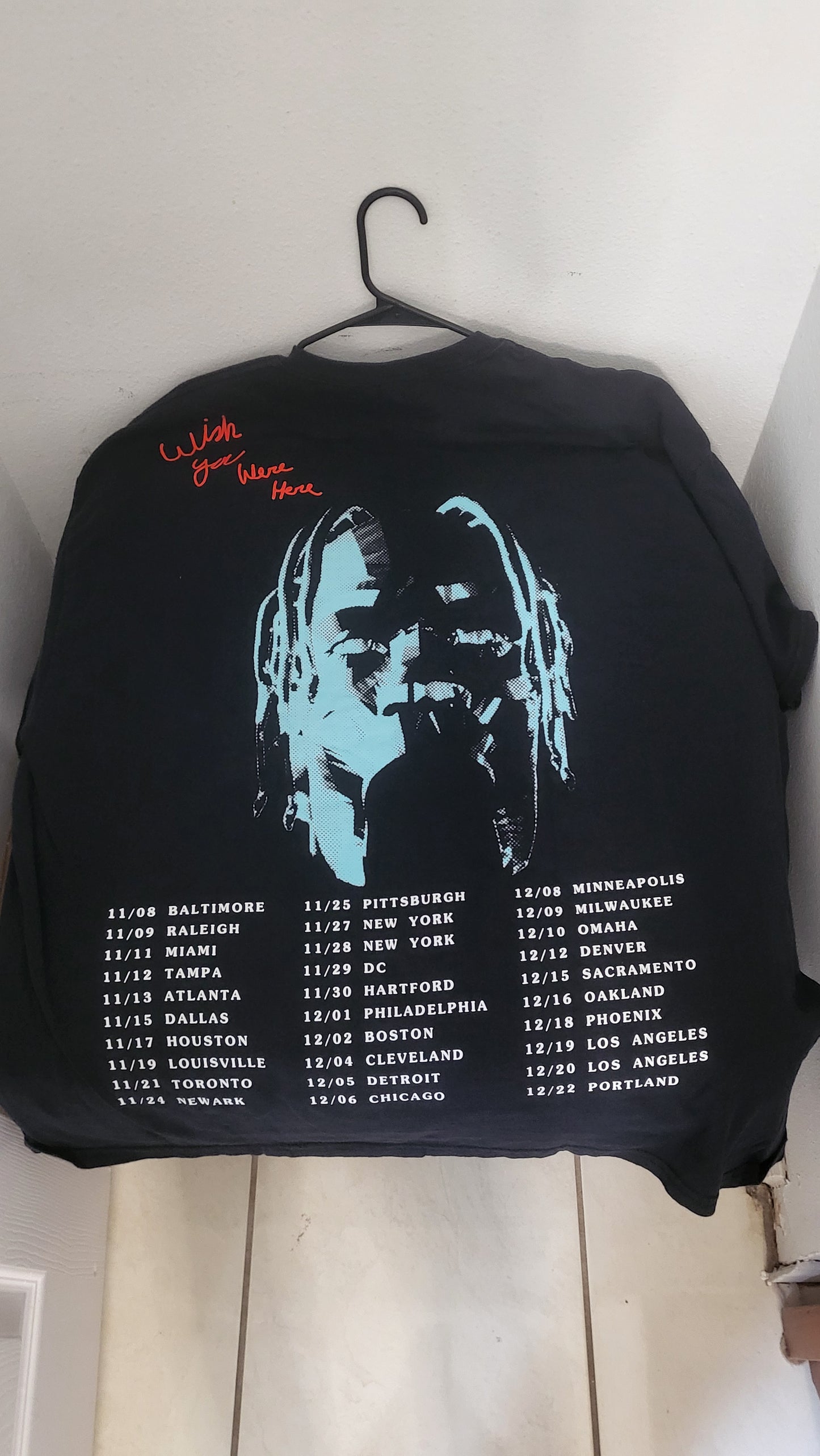 Back of ASTROWORLD tee showing Travis silhouette, red text, and full U.S. tour dates