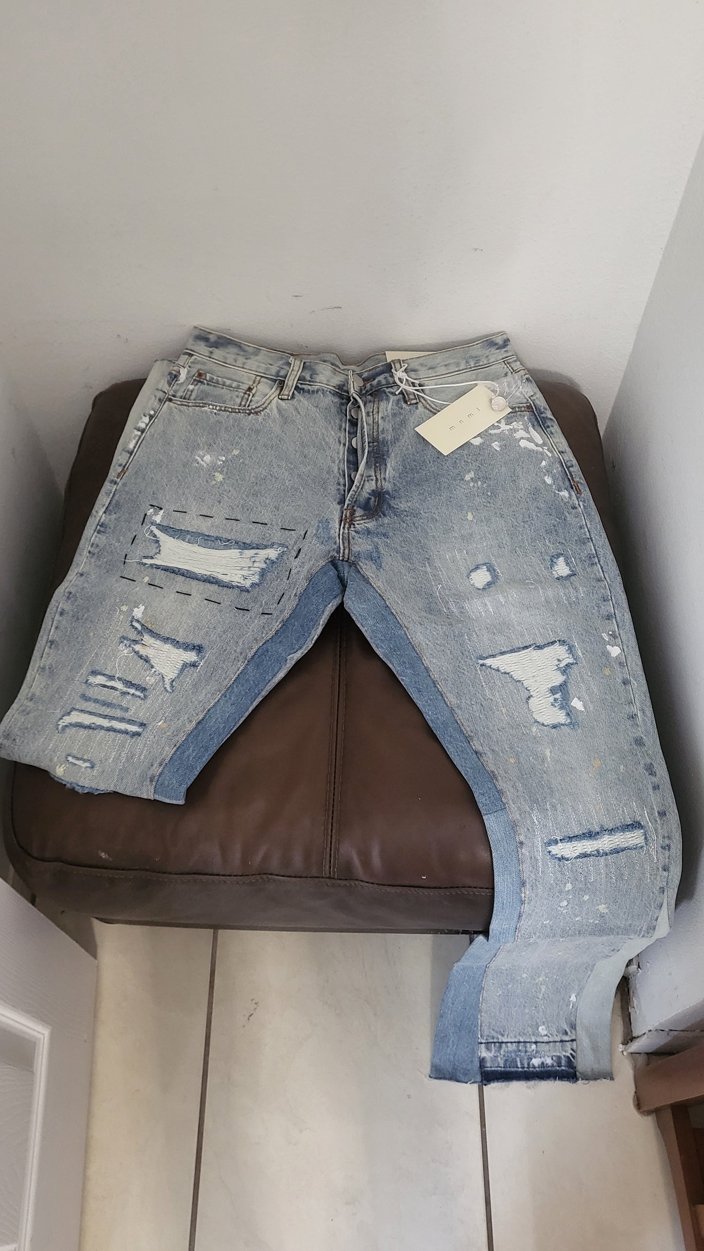 Close-up on MNML Slim Fit Jeans fabric and stitching details, showcasing premium denim quality
