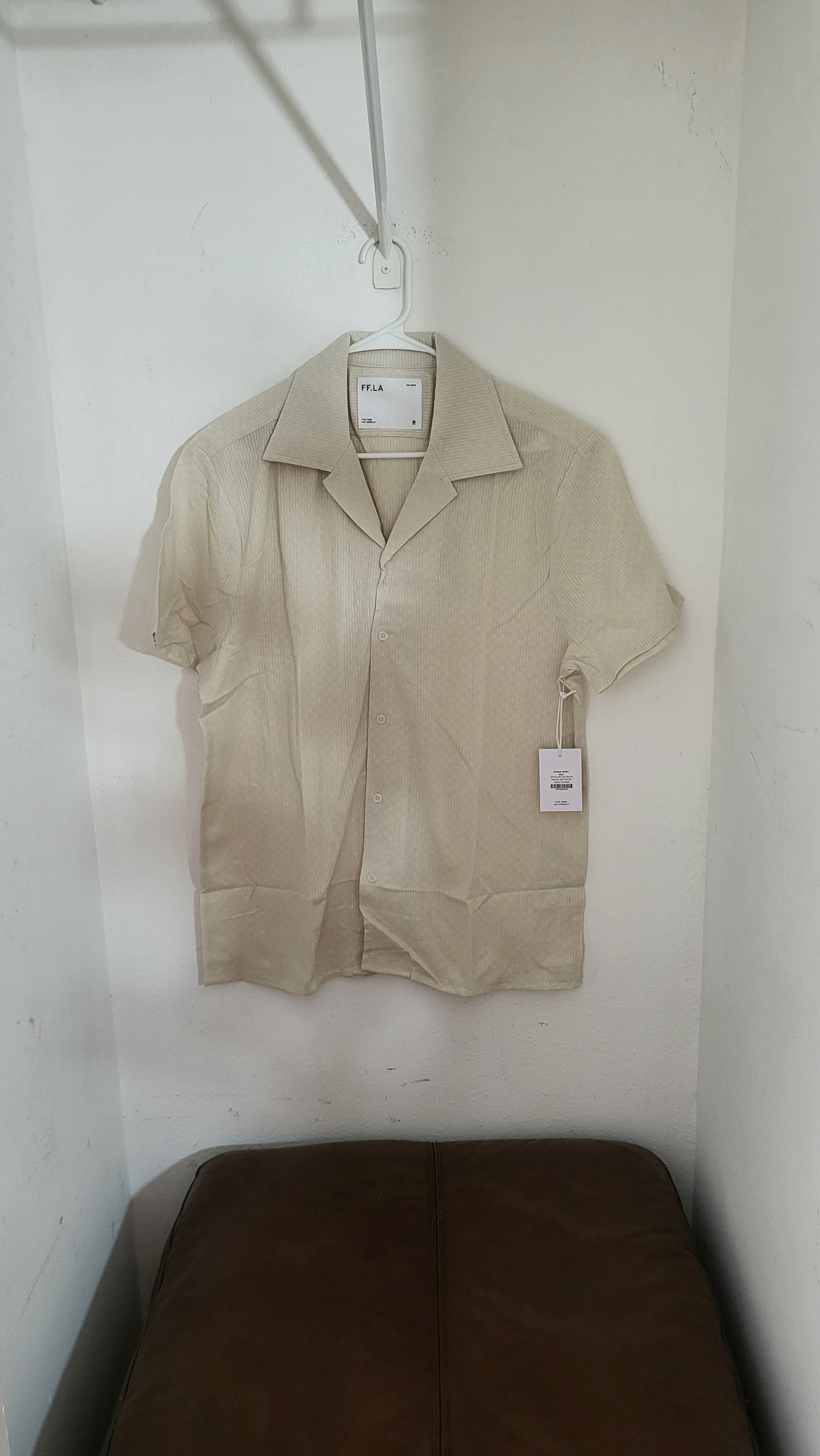 FF LA Cyrus cream short-sleeve button-up shirt displayed flat on leather couch, size L with hang tag visible