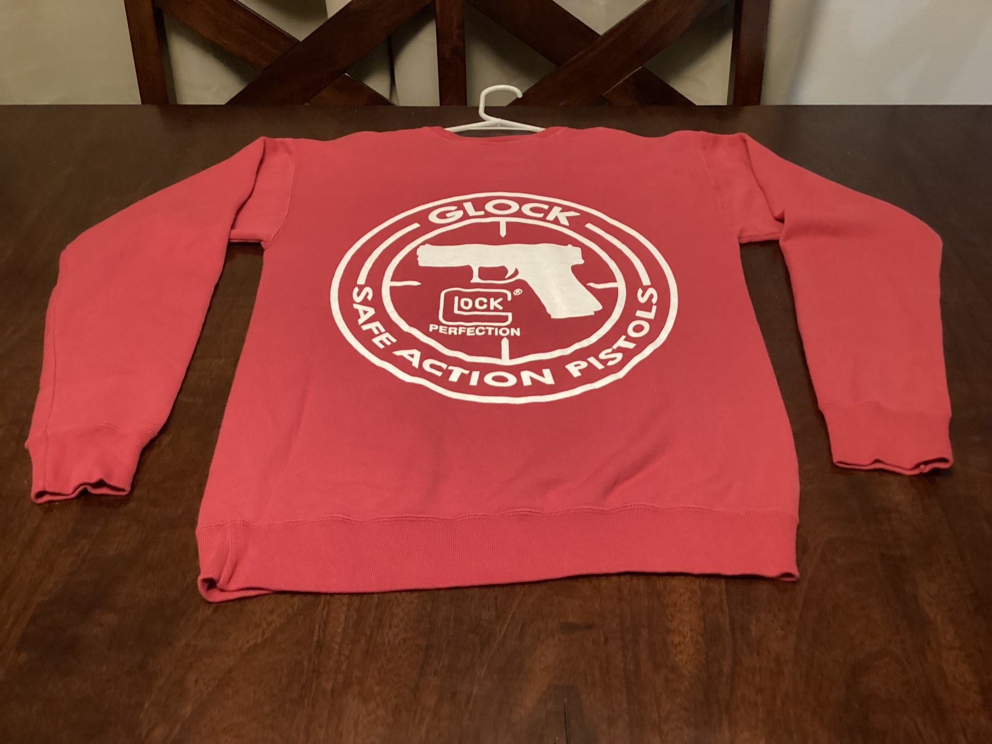 Vibrant red Team Glock Crewneck Sweatshirt in size small, featuring Safe Action Heat design—perfect blend of comfort and streetwear style from ShAesthetics