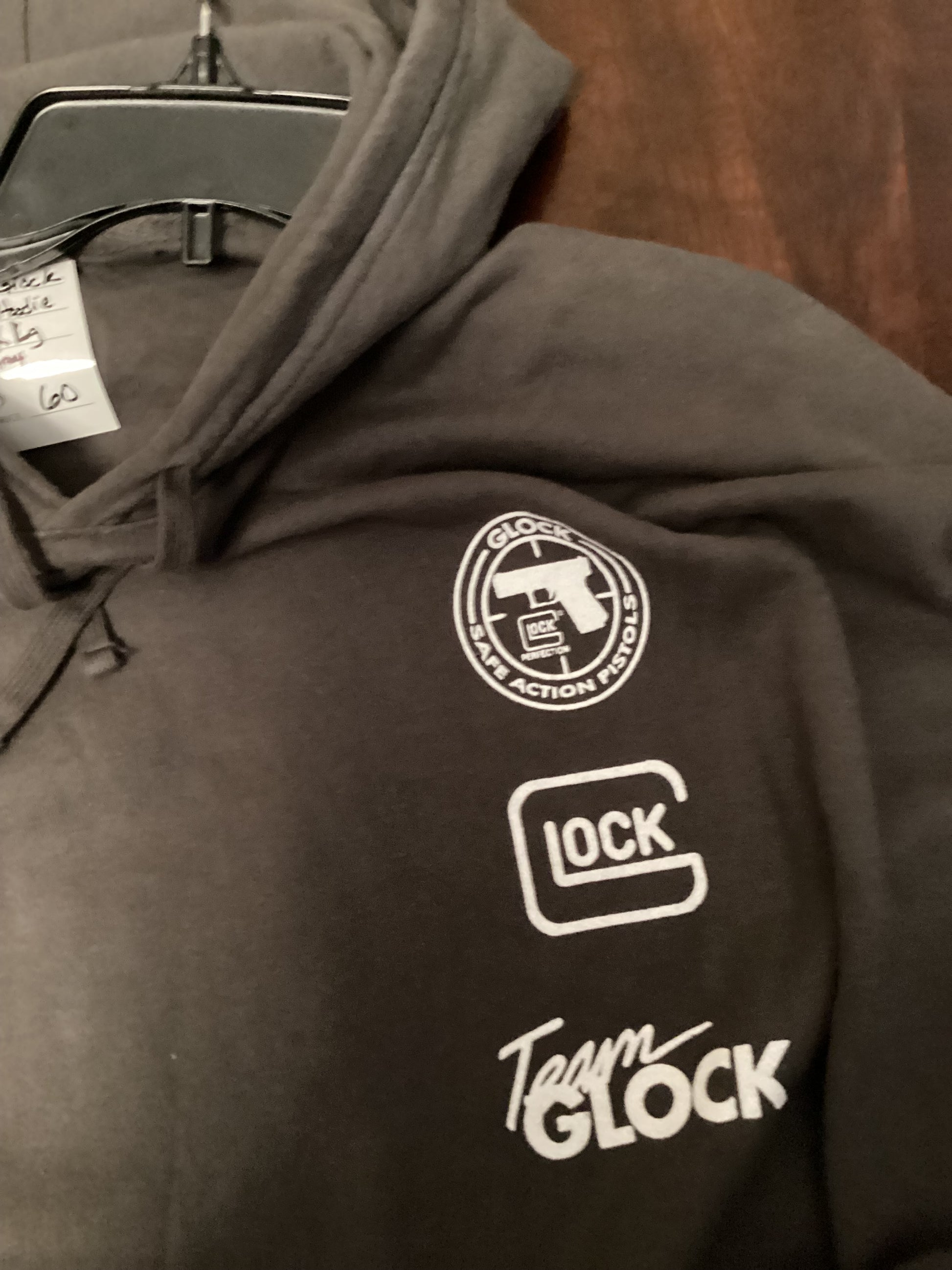 Close-up of official Team Glock logo on charcoal gray hoodie size 3XL from ShAesthetics