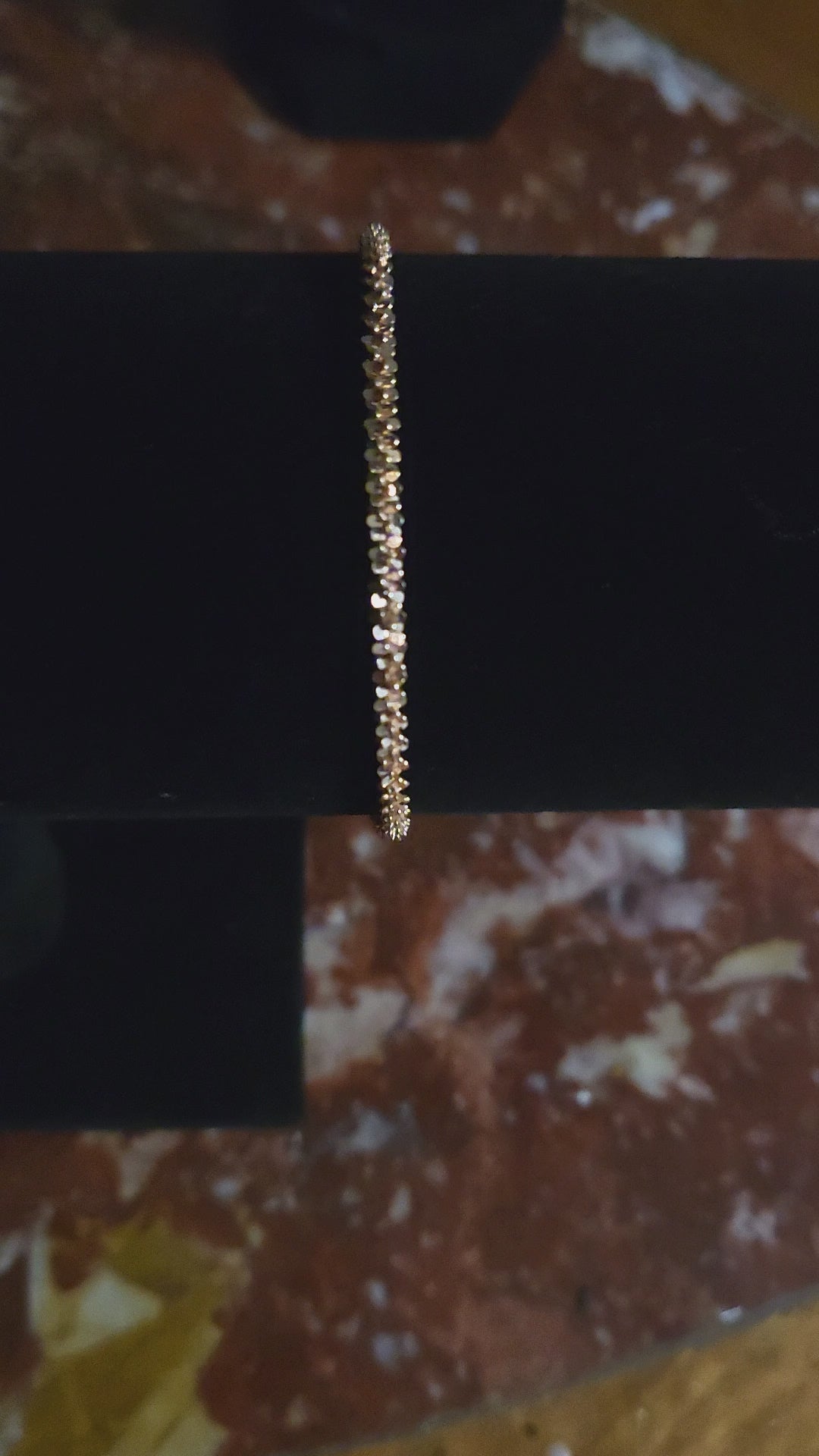 Detailed view of tightly woven spiral rose gold bracelet showing texture and shimmer