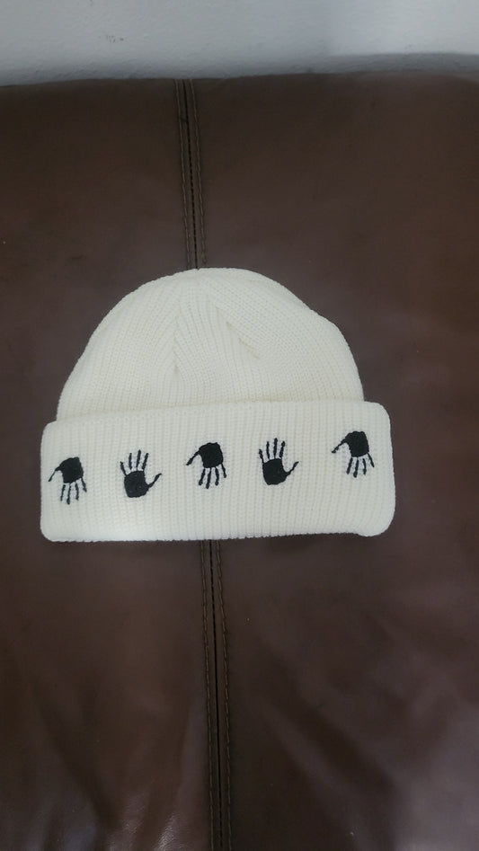 10.Deep Many Hands Beanie in Off White with black hand embroidery on the fold