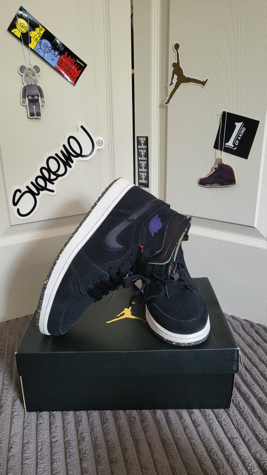 Side view of both Air Jordan 1 Mid SE sneakers showing suede texture and speckled sole.
