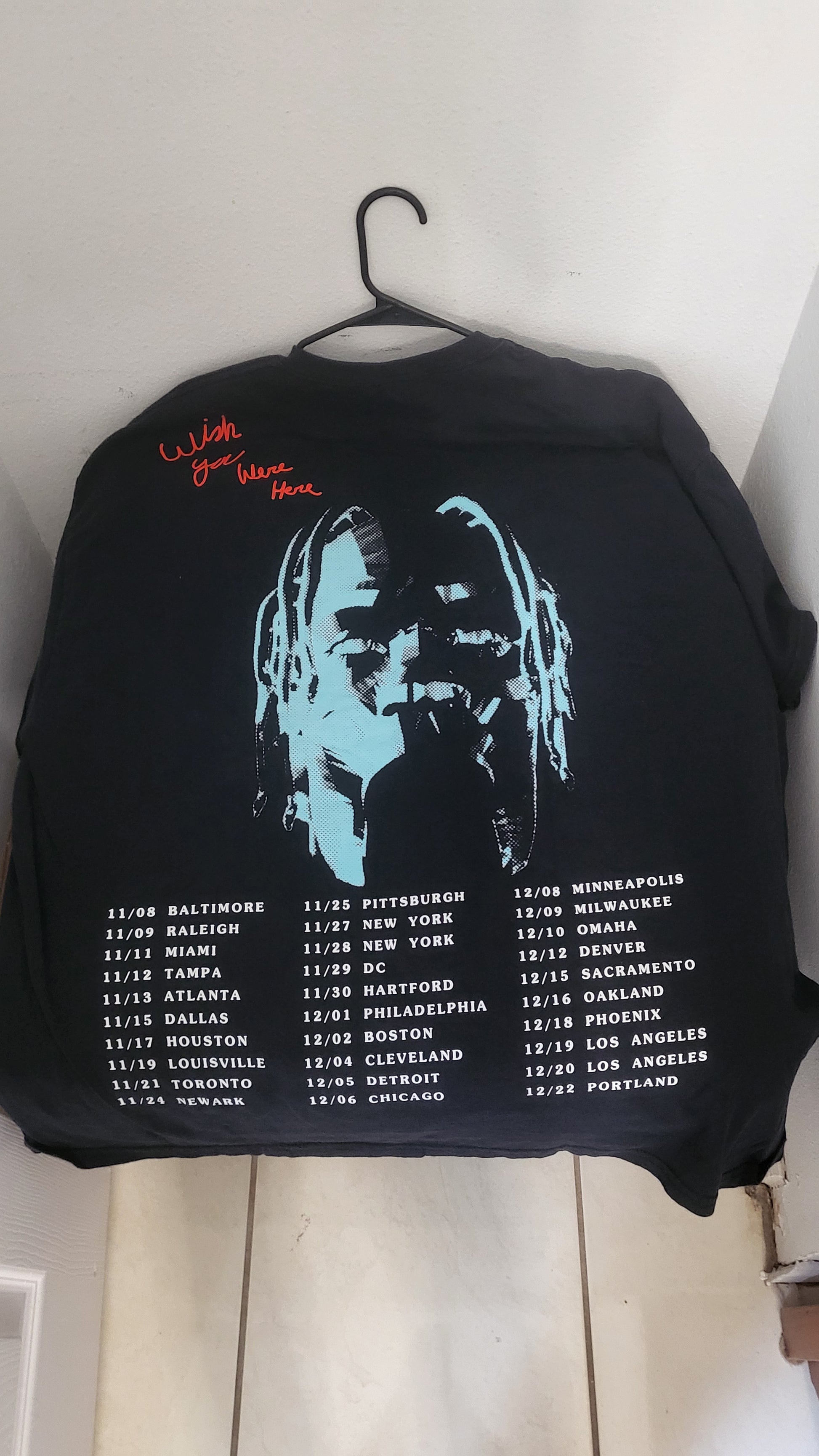 Back of ASTROWORLD tee showing Travis silhouette, red text, and full U.S. tour dates