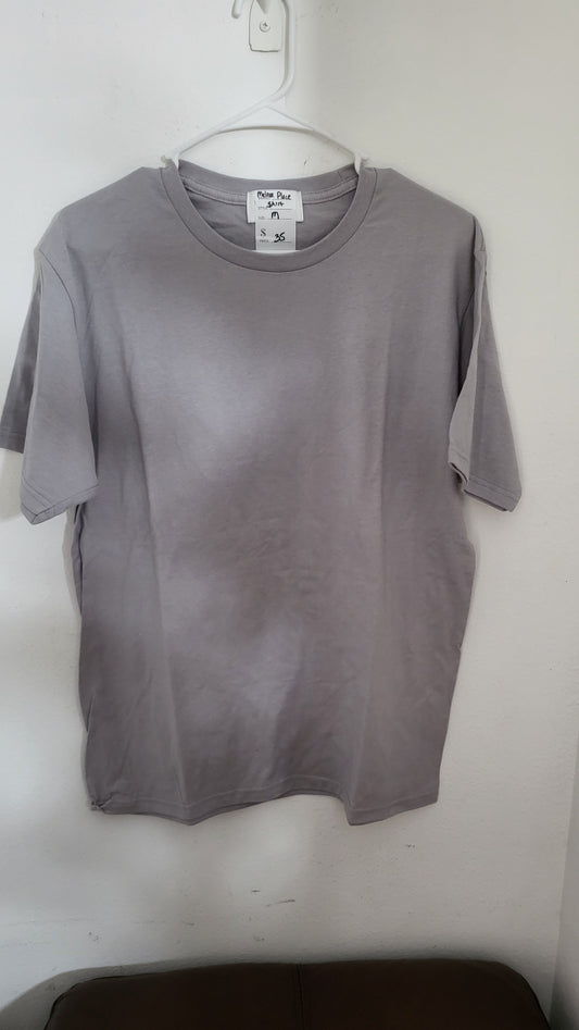 Full view of Melrose Place washed lavender t-shirt hanging on white hanger against a light wall