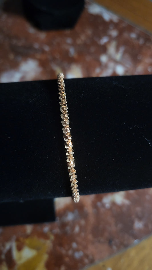 Close-up of 7.5-inch twisted rose gold Italian chain bracelet on black velvet display